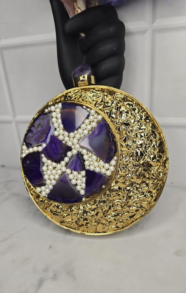 A beautiful handmade golden clutch bag with embroidery designs