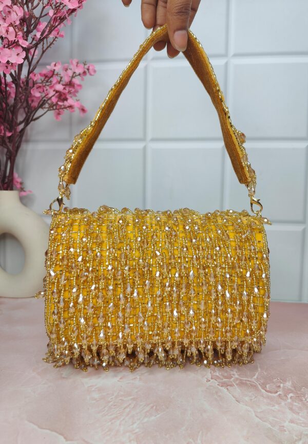 An elegant gold color flap clutch bag